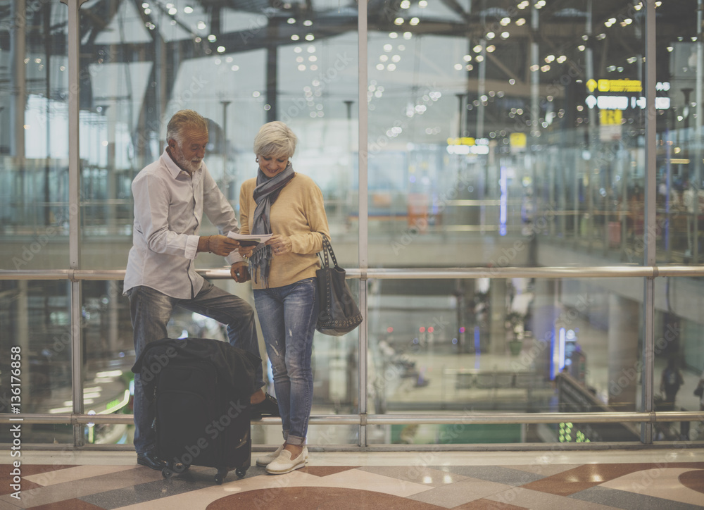 Senior couple traveling airport scene