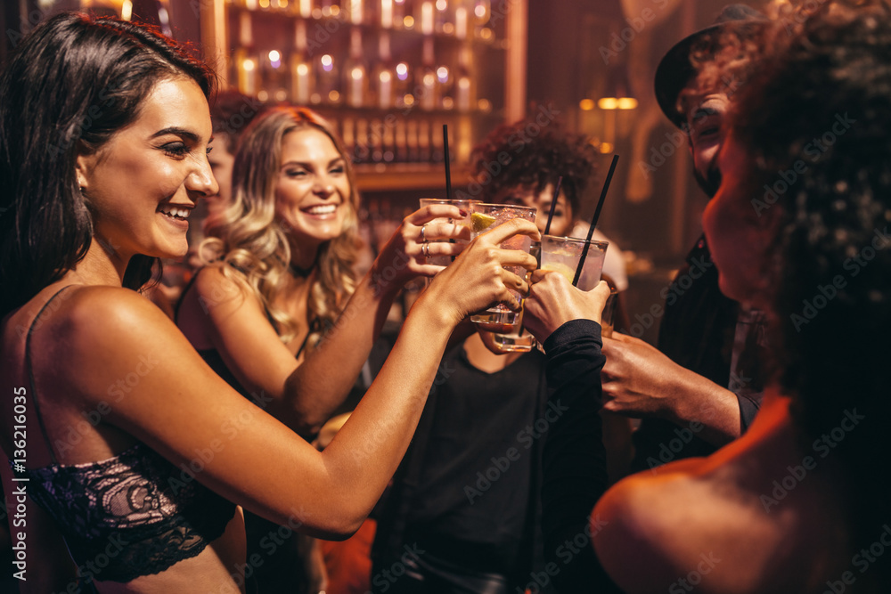 Young people with cocktails at nightclub