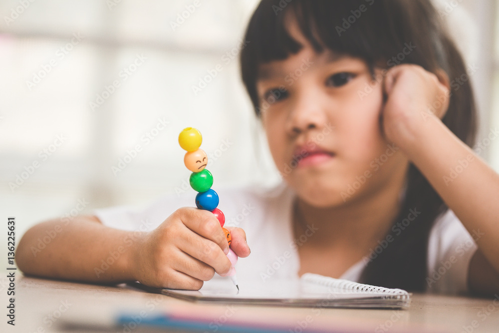 asia girl exasperated with his homework