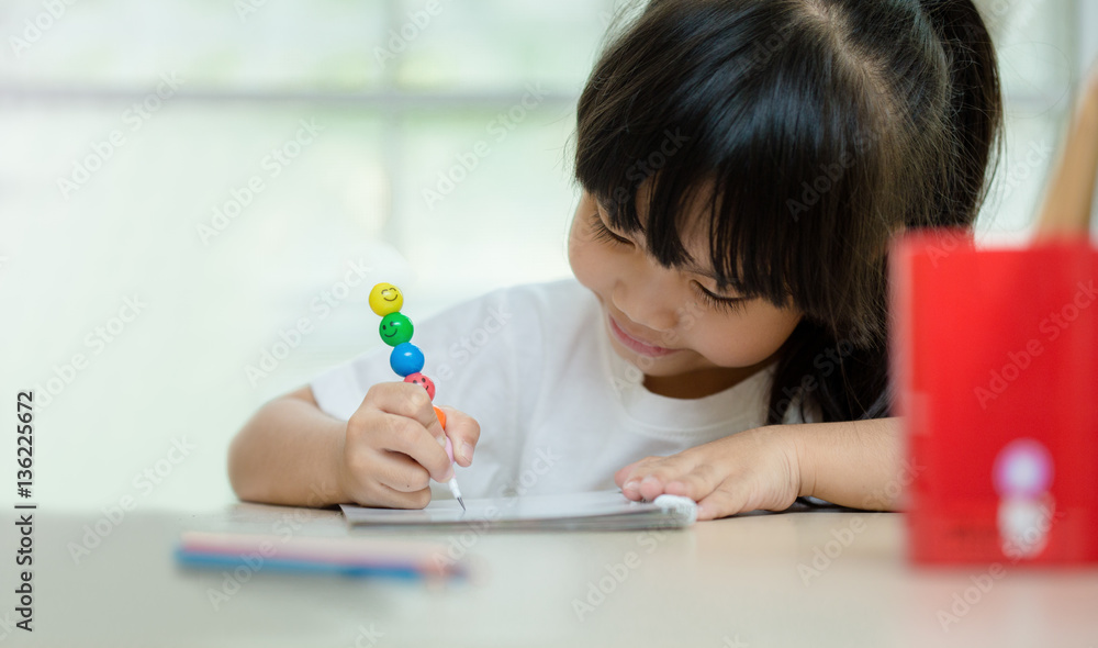 happy schoolgirl , childhood and education concept - happy little girl with chalk drawing