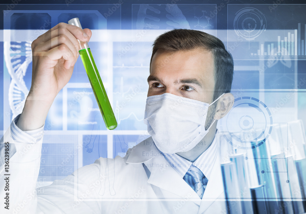 Young scientist mixing reagents in glass flask in clinical laboratory