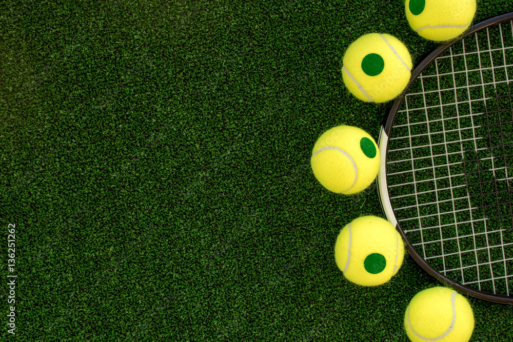 tennis racket on green background top view