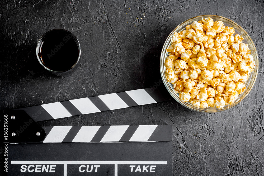 concept of watching movies with popcorn top view dark background