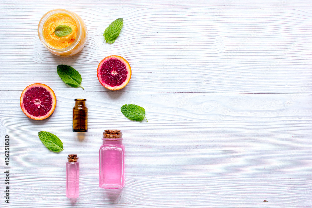 organic cosmetic with citrus on wooden background top view