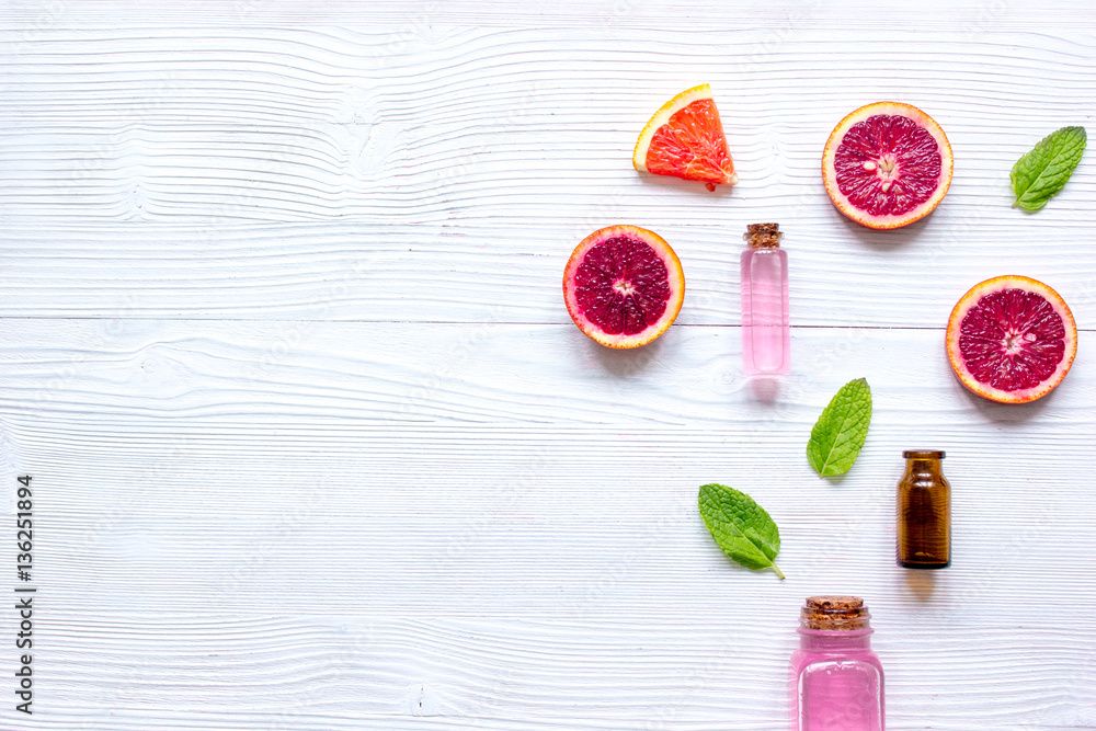 organic cosmetic with citrus on wooden background top view