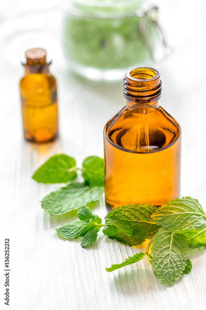 organic cosmetics with herbal extracts of mint on wooden background