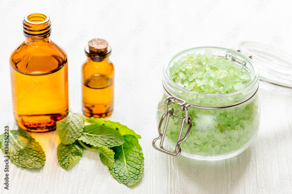 organic cosmetics with herbal extracts of mint on wooden background