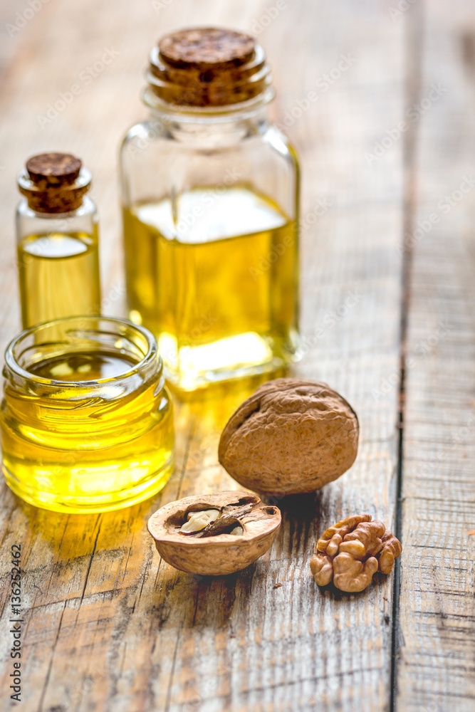 cosmetic and therapeutic walnut oil on wooden background