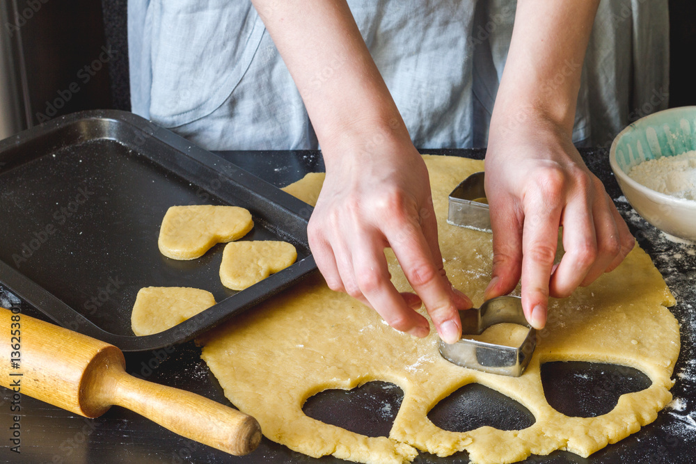 cooking homemade cookies with hands on dark background