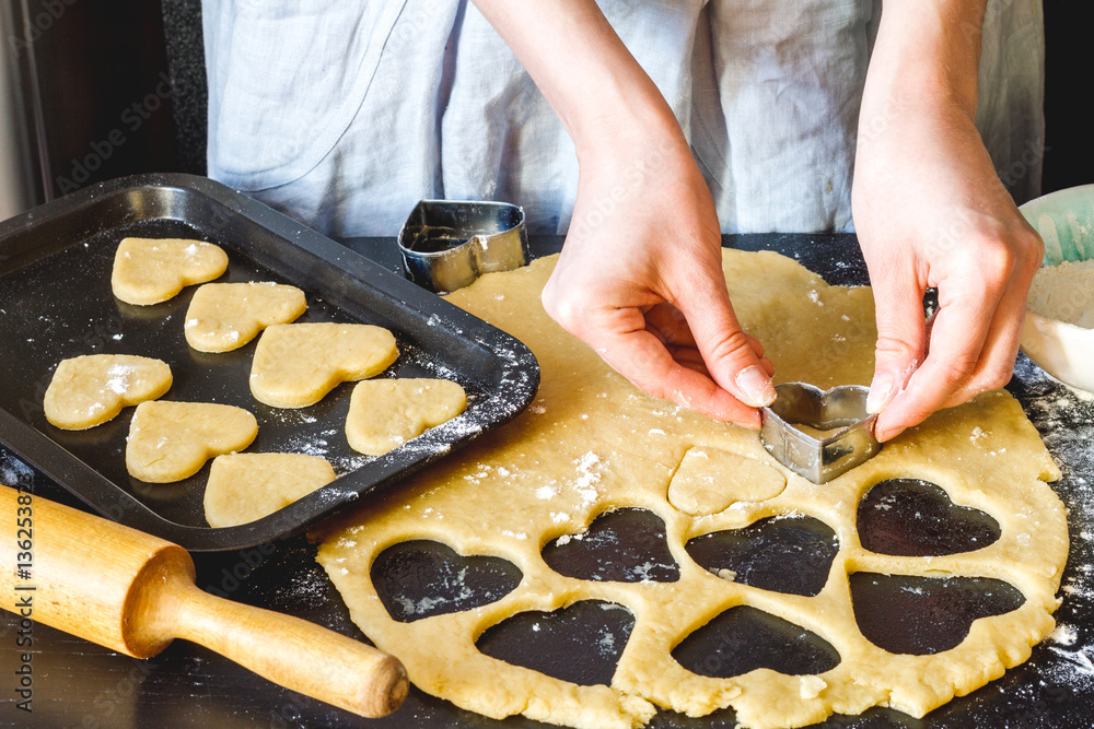 cooking homemade cookies with hands on dark background