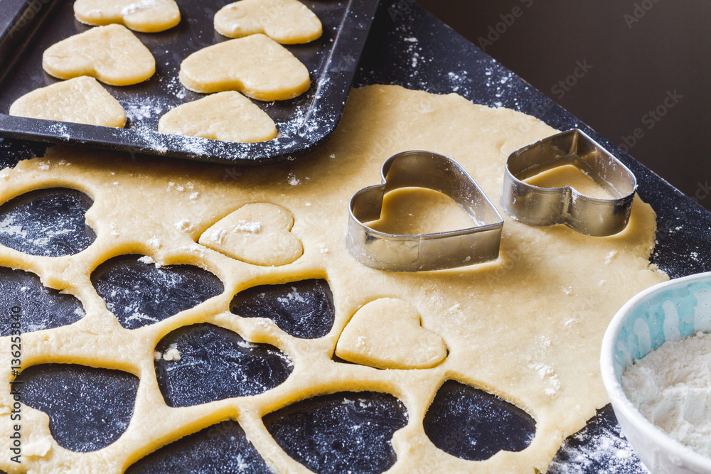 cooking homemade cookies with hands on dark background