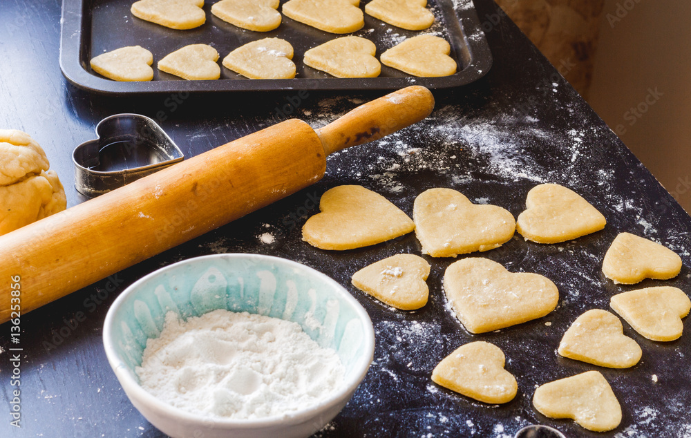 cooking homemade cookies with hands on dark background