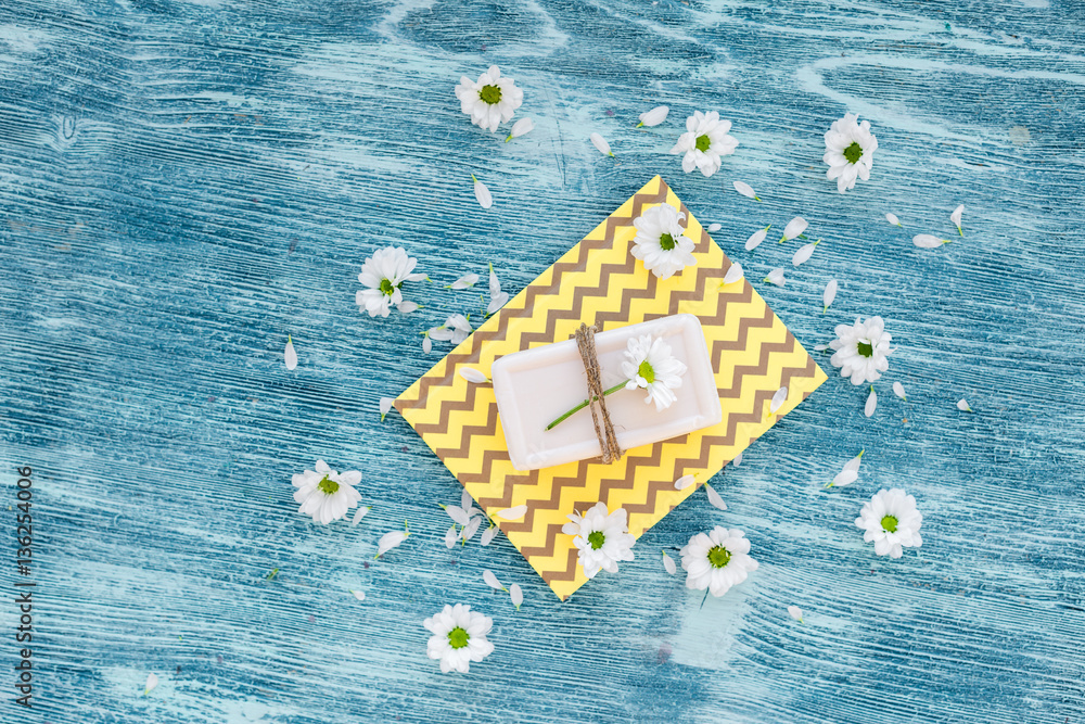 organic cosmetics with camomile on blue background top view