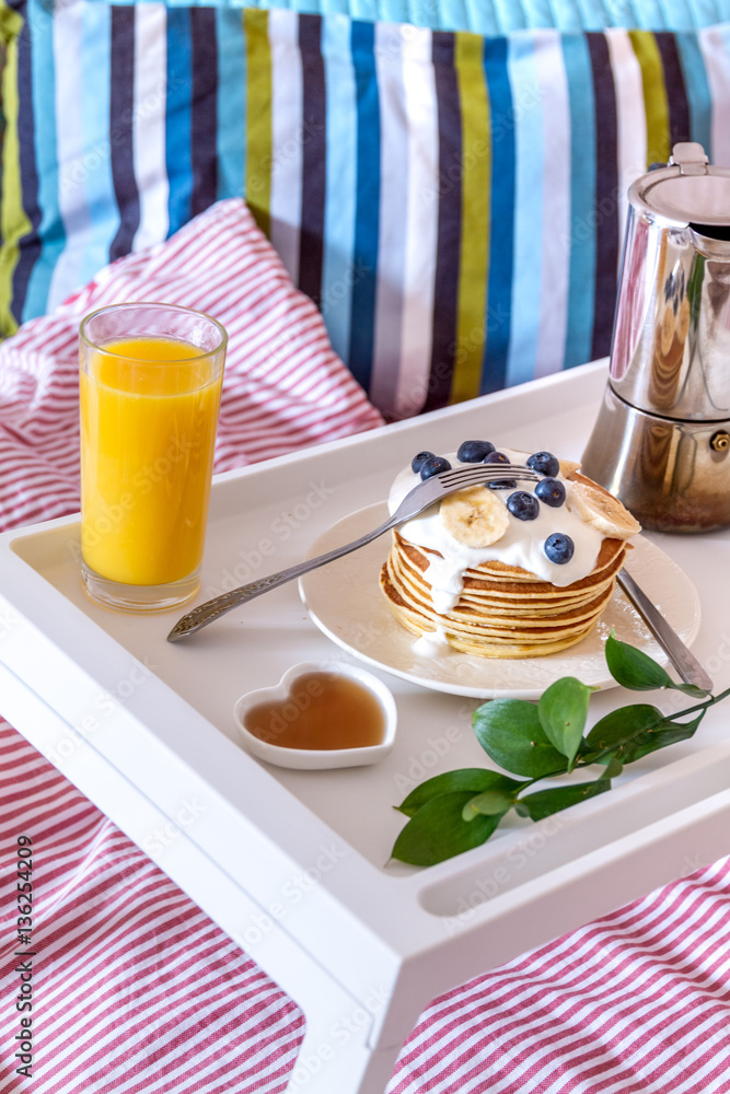 concept of breakfast in bed on tray with juice