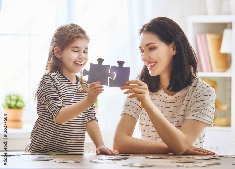 Mother and daughter do puzzles