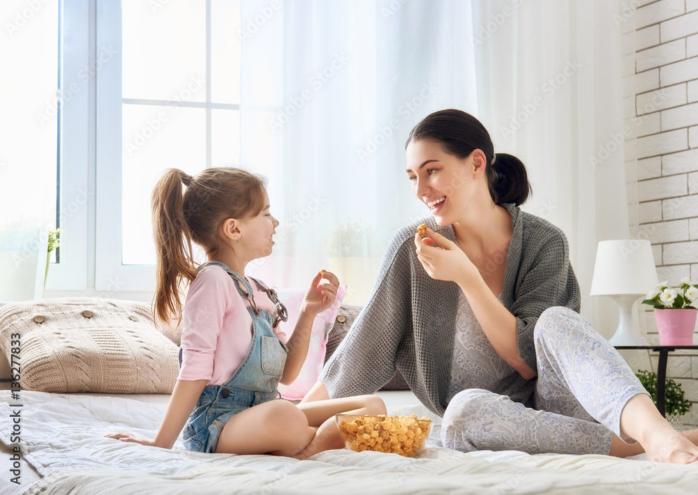 Mother and daughter eating popcorn