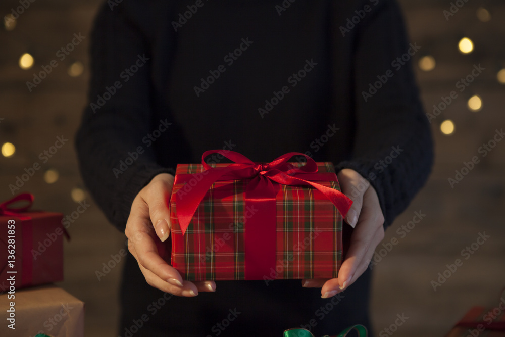 Women are handing Christmas gifts