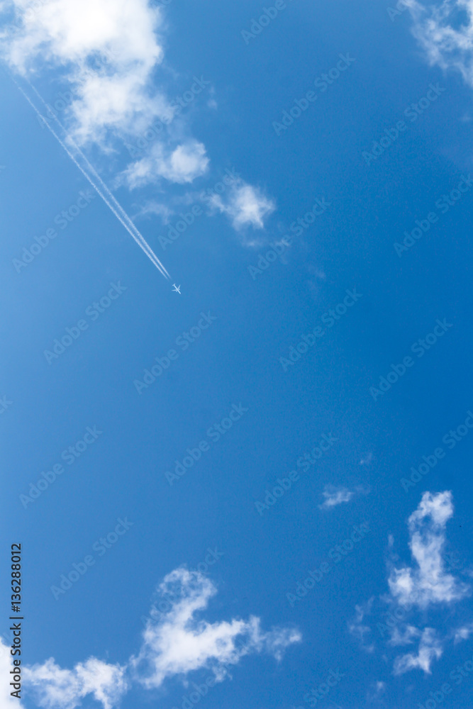 The plane in the blue sky