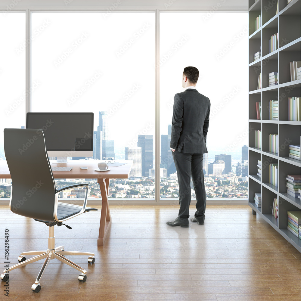 Businessman in room with workplace