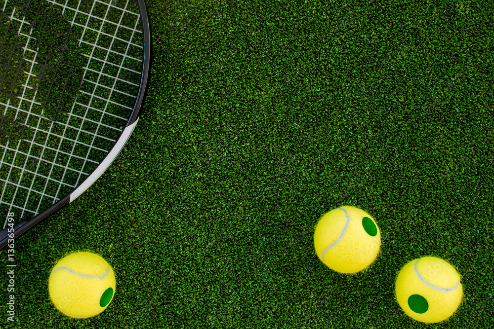 tennis racket on green background top view