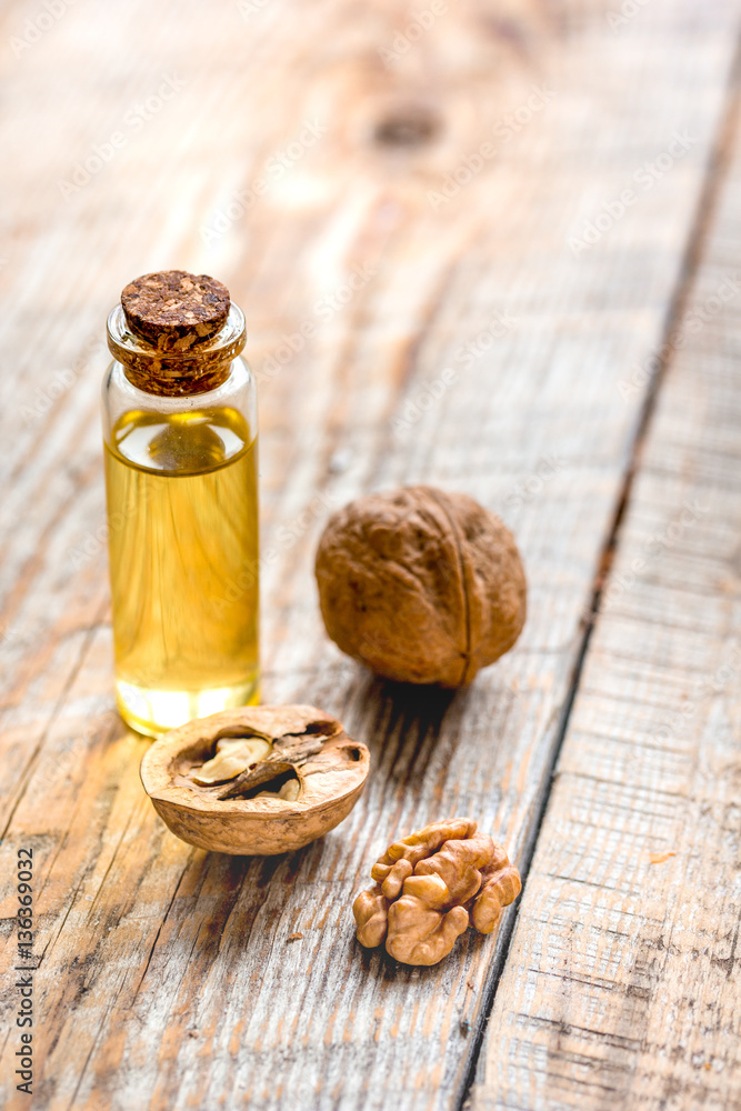 cosmetic and therapeutic walnut oil on wooden background