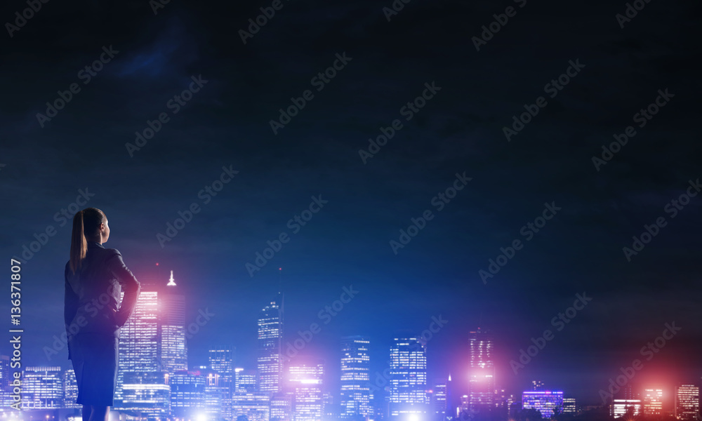 Woman looking at night city