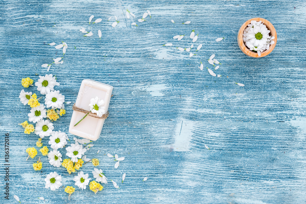 organic cosmetics with camomile on blue background top view