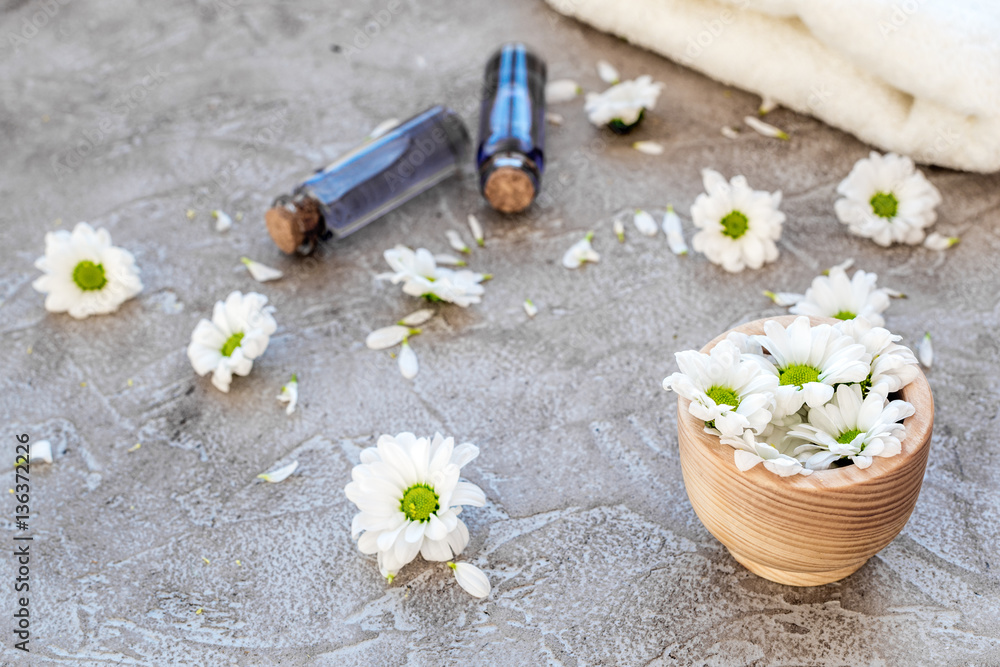 organic cosmetics with camomile on stone background