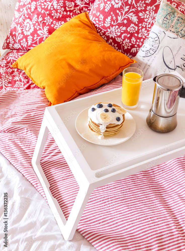 concept of breakfast in bed on tray with juice