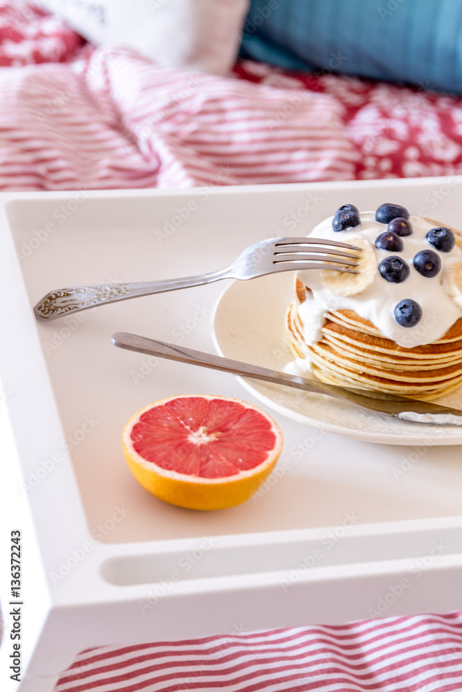 concept of breakfast in bed on tray with juice