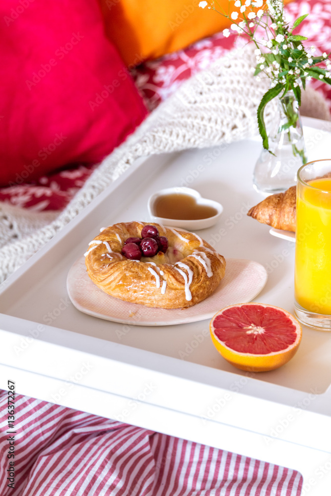 concept of breakfast in bed on tray with juice