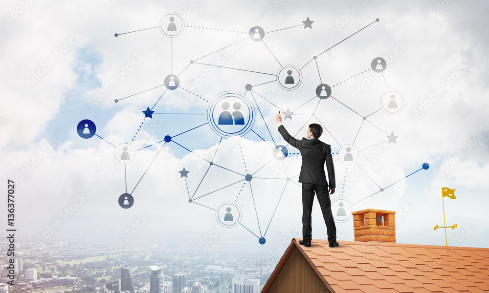 Businessman on house roof presenting networking and connection concept. Mixed media