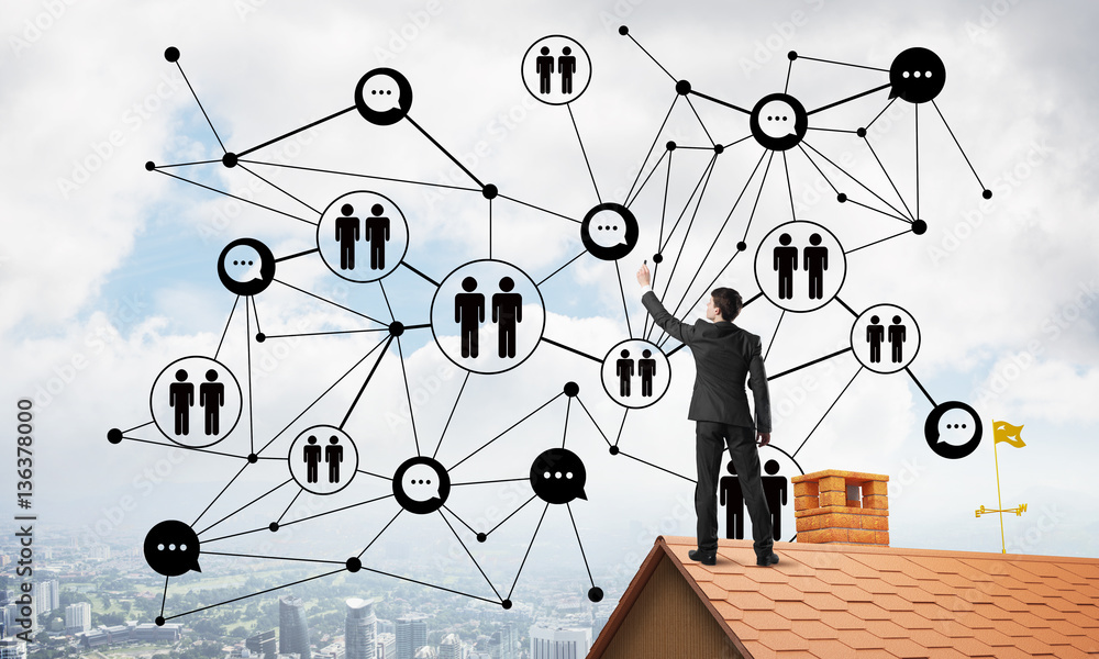 Businessman on house roof presenting networking and connection concept. Mixed media