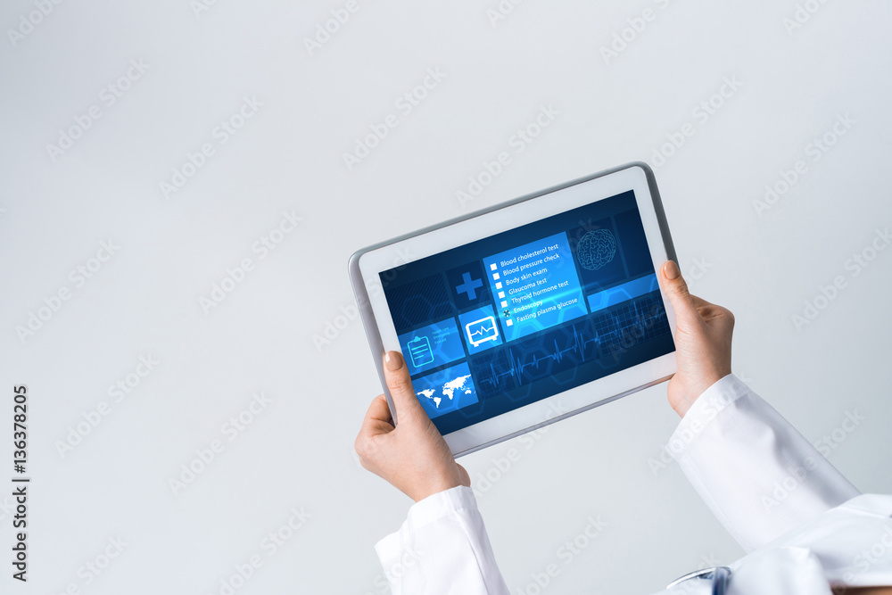 Close of female doctor hands working with tablet pc computer