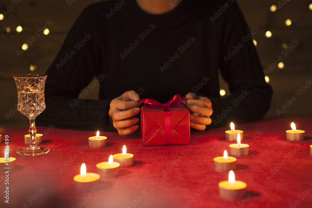 The woman is surrounded by a candle and received a gift