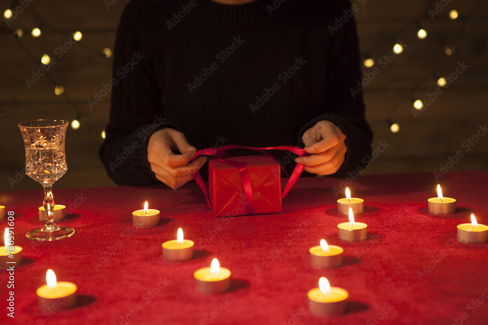 The woman is surrounded by a candle and received a gift