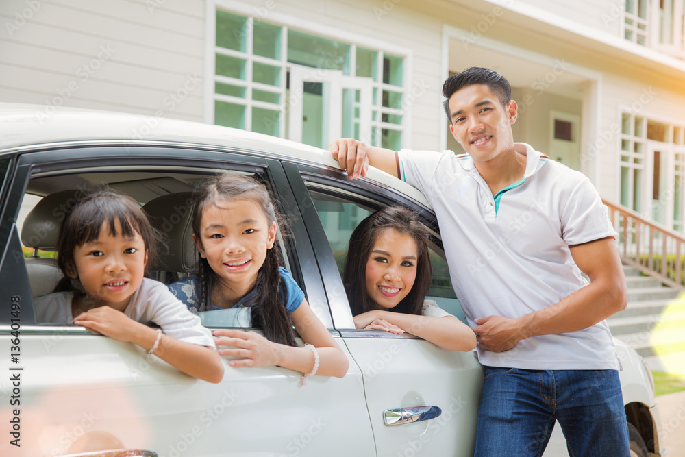 Beautiful family portrait smiling outside their new house