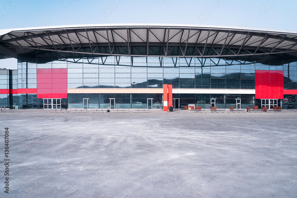 empty concrete floor and modern building with abstract top