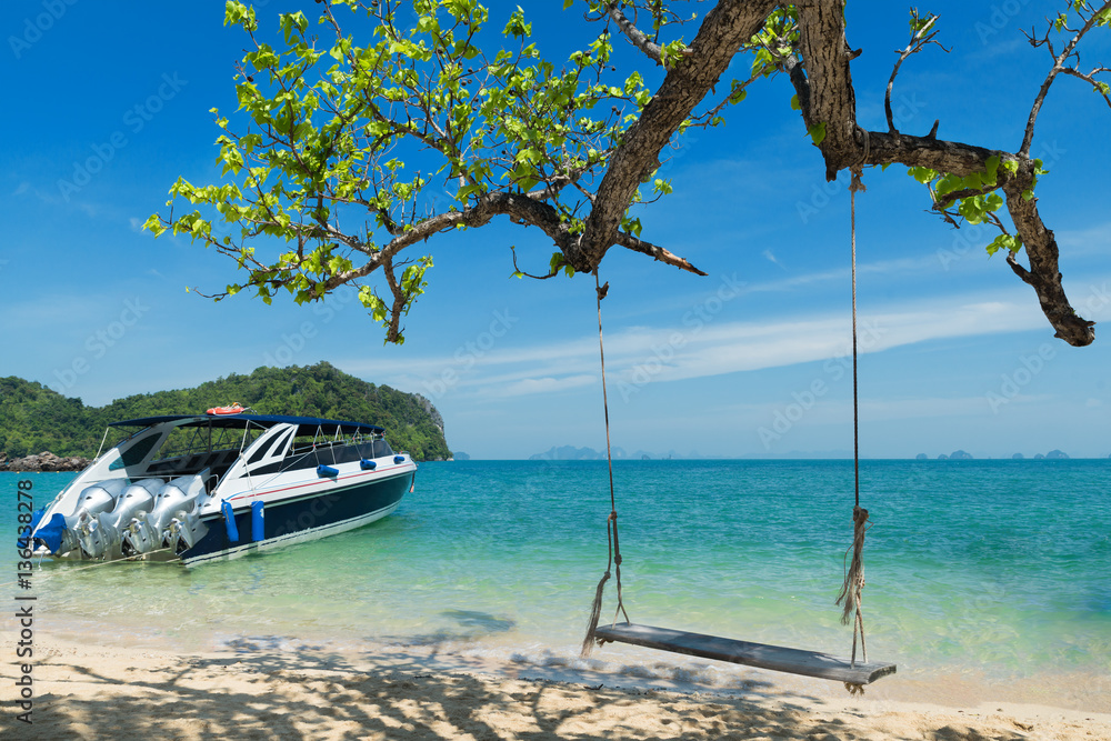 Wooden swing chair hanging on tree near beach at island in Phuke