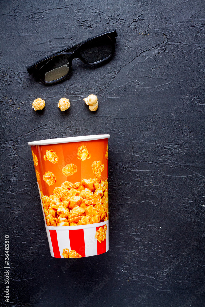 concept of watching movies with popcorn top view dark background