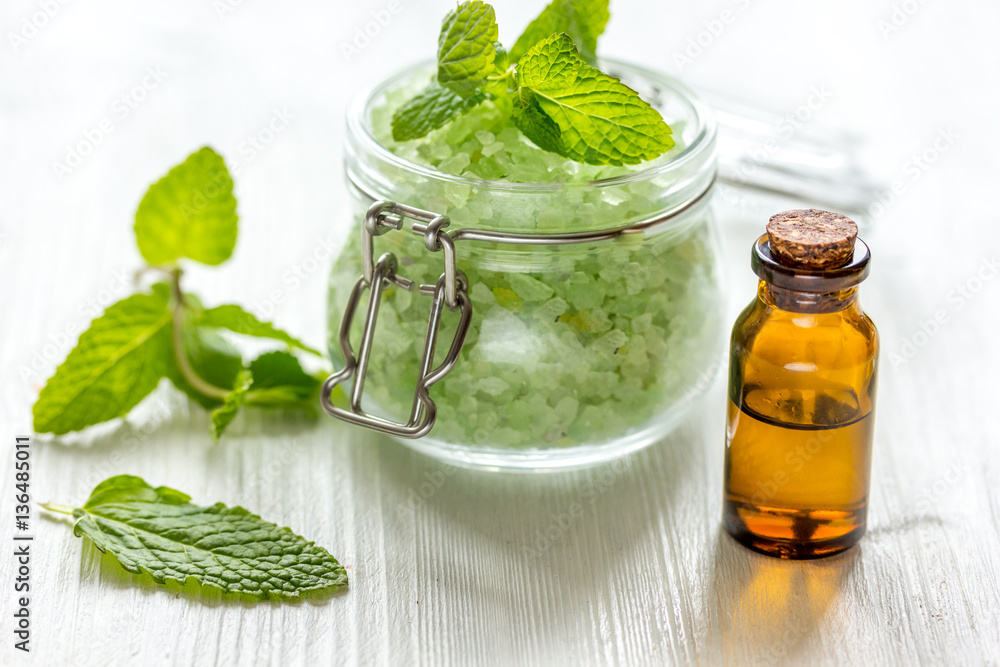 organic cosmetics with herbal extracts of mint on wooden background