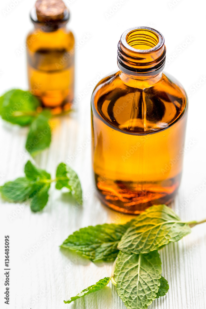 organic cosmetics with herbal extracts of mint on wooden background