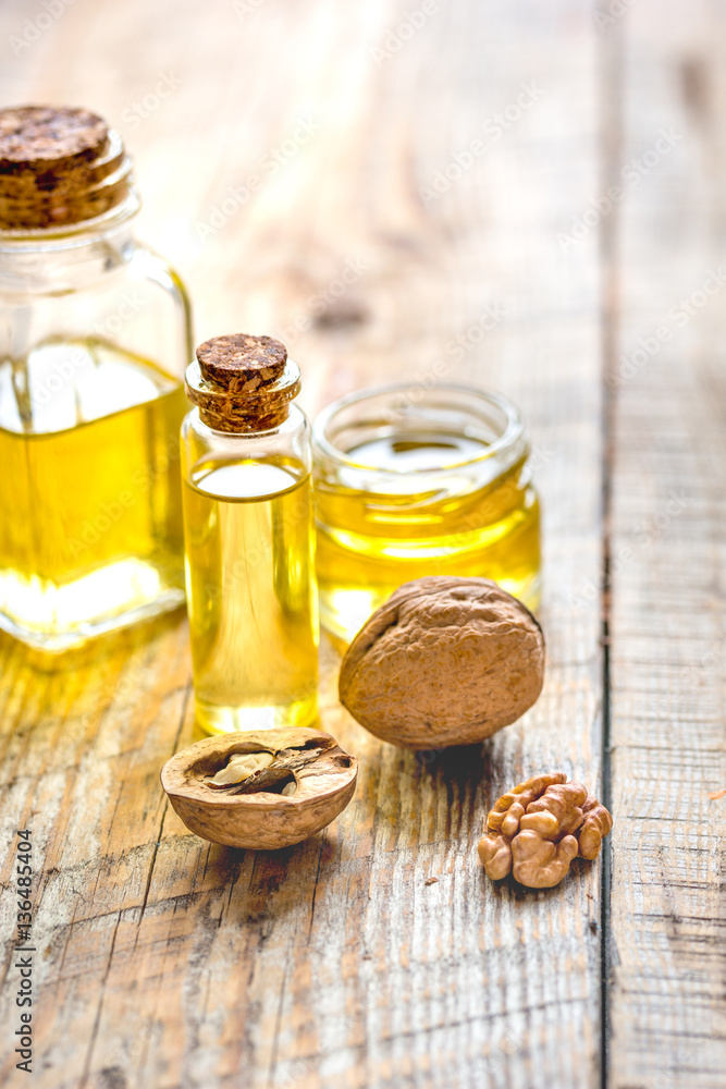 cosmetic and therapeutic walnut oil on wooden background