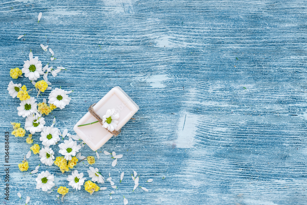 organic cosmetics with camomile on blue background top view