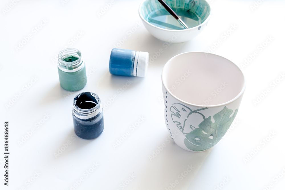 painted ceramic cup on white background