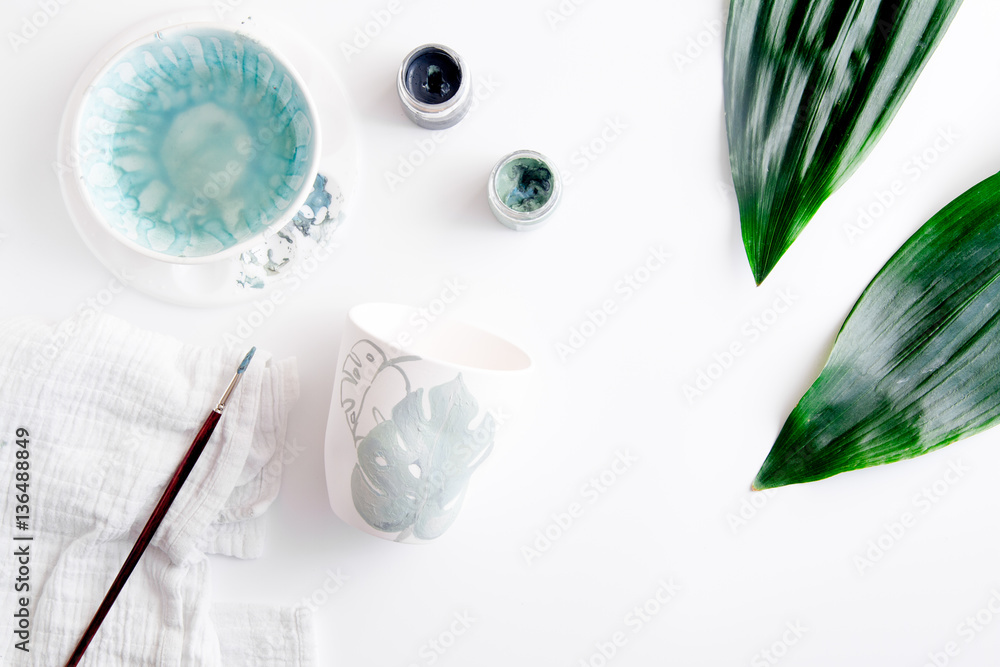 painted ceramic cup on white background top view