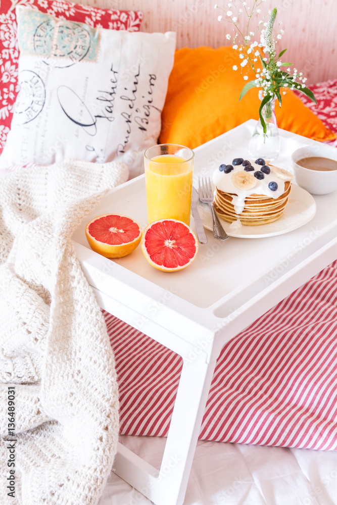 concept of breakfast in bed on tray with juice