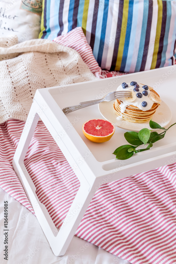 concept of breakfast in bed on tray with juice