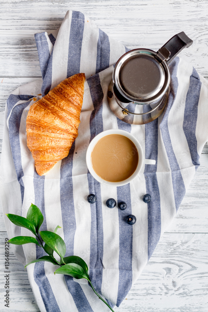 Breakfast concept with flowers on wooden background top view