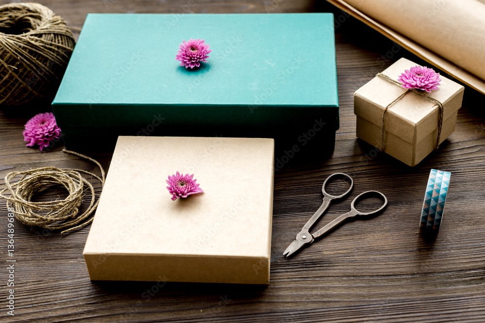 wrapping gifts in box for holiday on wooden background